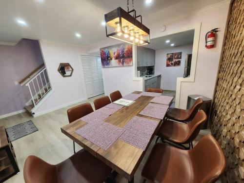 a dining room with a wooden table and chairs at Modern Island Serenity!-Pet-Friendly villa in Hilton Head Island