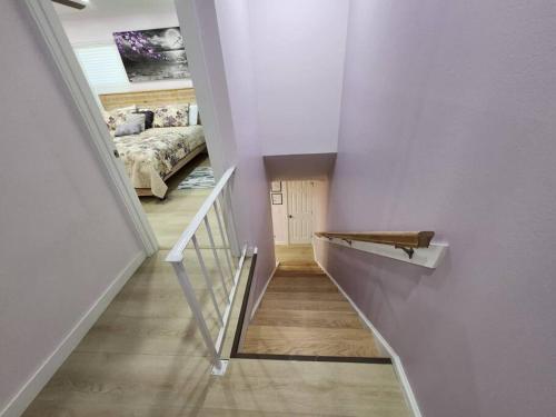 a hallway with a staircase with a bed in a bedroom at Modern Island Serenity!-Pet-Friendly villa in Hilton Head Island