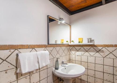 a bathroom with a sink and a mirror at L'antico borgo di Trastevere III in Rome