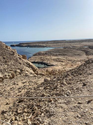 a view of the ocean from a rocky beach at Blend in Nature Eco Camp Beachfront Stay in Ras Mohamed, Sharm El Sheikh in Sharm El Sheikh
