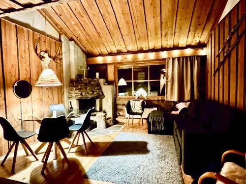 a living room with a couch and chairs at Lapland Tunturimaja Ski in, sauna, wifi, in Pyhä center - Lapland Villas in Pyhätunturi