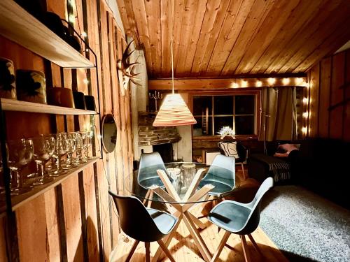 a dining room with a glass table and chairs at Lapland Tunturimaja Ski in, sauna, wifi, in Pyhä center - Lapland Villas in Pyhätunturi
