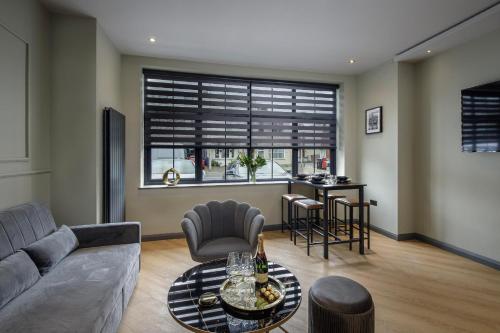 a living room with a couch and a table at Signature Apartments in Blackpool