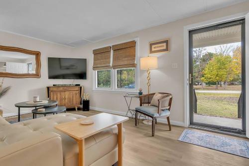 a living room with a couch and a tv at Pet friendly - steps to water! in Salter Path