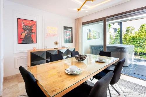 a dining room with a wooden table and chairs at Appartement Duplex G1 in Casablanca