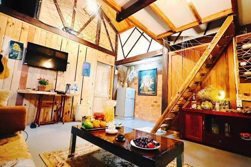 - un salon avec une table et des fruits dans l'établissement Romantic house 2 on a pine hill Dalat, à Đà Lạt
