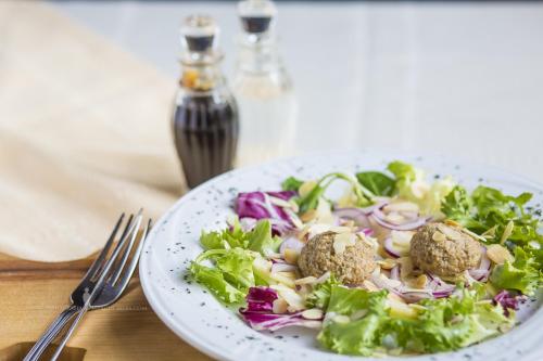 a plate of food with a salad on a table at W Starym Młynie in Milicz