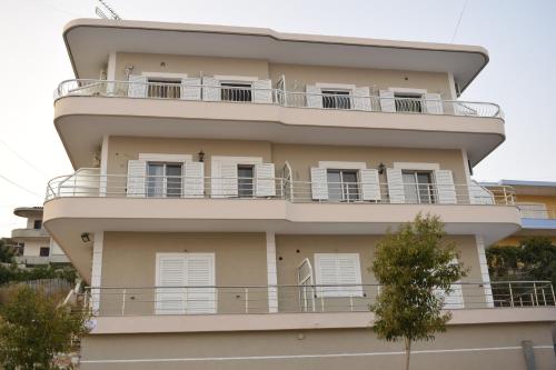 an apartment building with balconies on the side of it at Isabela Apartments in Sarandë