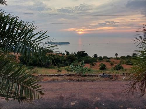 a view of the ocean with a rainbow in the sky at Seascape Residency in Dapoli