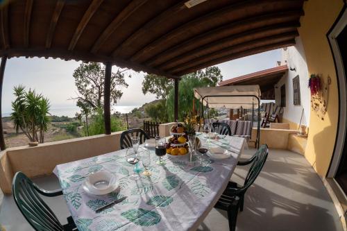 a table on the balcony of a house at Casa Giardinello in Ribera