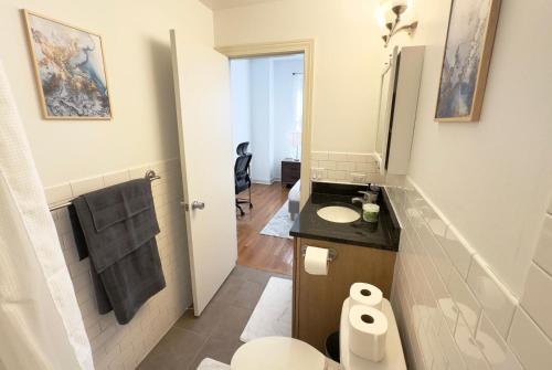 a bathroom with a toilet and a sink at Prime Location! 3BRGem near University of Chicago in Chicago