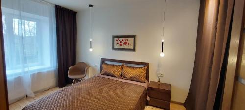 Ένα ή περισσότερα κρεβάτια σε δωμάτιο στο Prie Vingio parko