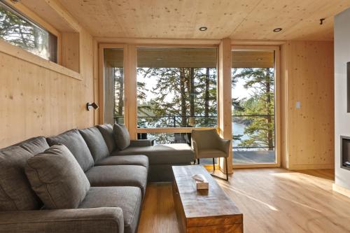 a living room with a couch and a table at The Cabins at Terrace Beach in Ucluelet