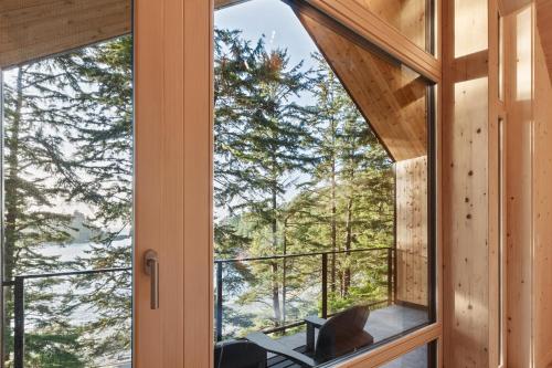a view from the door of a cabin with a balcony at The Cabins at Terrace Beach in Ucluelet