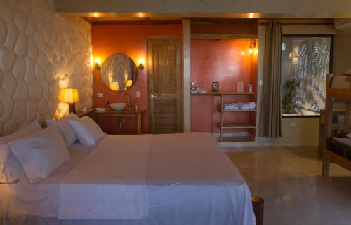 a bedroom with a large white bed and a mirror at ADA MARINA - 3 acomodaciones con jacuzzi, malla y vista a Cartagena, 1 acomodacion con jacuzzi escondido, zona social con piscina infinita in Turbaco