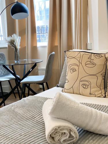 a bed with a pillow with a face on it at Holland Road Stays in London