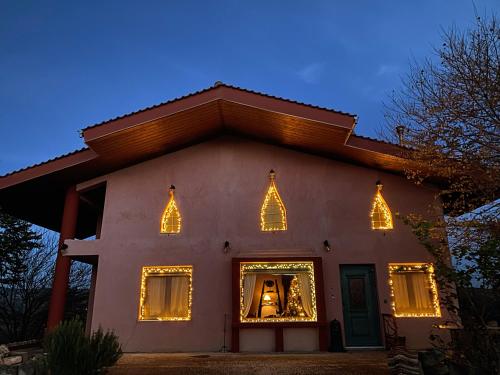 a house with christmas lights in the window at Dream Chalet Trikala in Tríkala