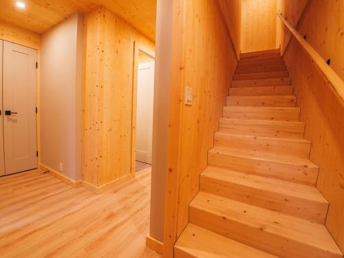 a staircase in a house with wooden walls at The Cabins at Terrace Beach in Ucluelet
