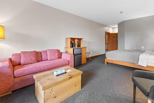 a living room with a couch and a bed at The Cabins at Terrace Beach in Ucluelet