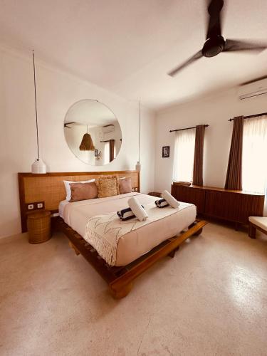 a bedroom with a large bed with a large mirror at Motel LOVE SONG Canggu in Canggu