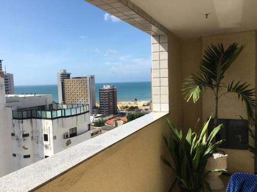 a balcony of a building with a view of the ocean at Apartamento MOBILIADO 200m do mar com vista mar, garagem, ar condicionado in Fortaleza