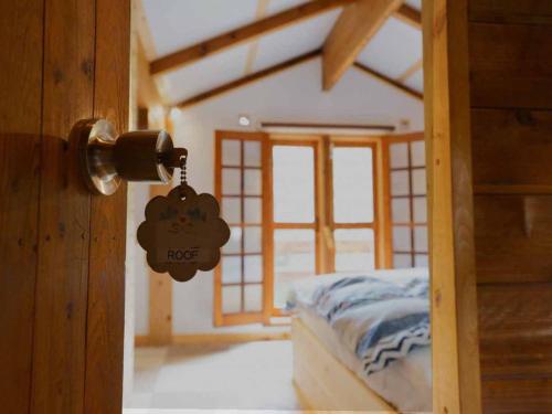 a bedroom with a door with a door tag on it at Alpages - Vacation STAY 11100 in Myoko