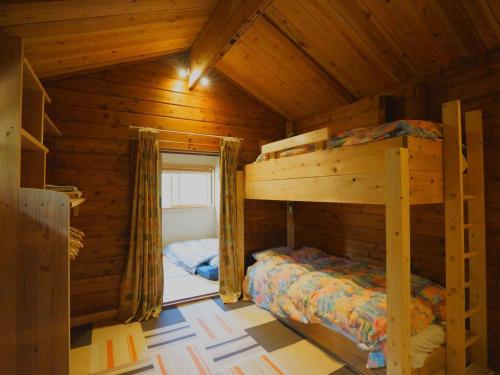 a bedroom with two bunk beds in a wooden cabin at Alpages - Vacation STAY 11099 in Myoko