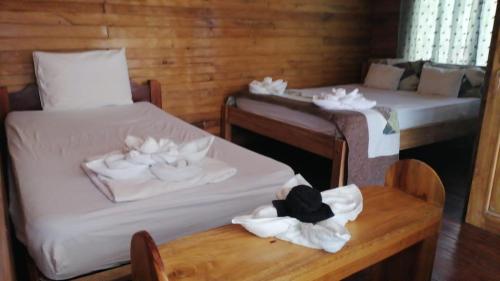 a room with two beds and a table with towels at Terrazas del Golfo in La Palma