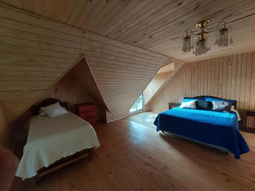 a bedroom with two beds in a attic at Peumayen in Quellón