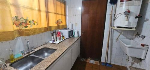 a small kitchen with a sink and a sink at Departamento Erlich in Godoy Cruz