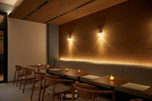a row of tables and chairs in a restaurant at HOTEL SAILS in Osaka