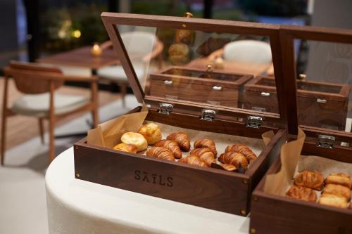 two boxes of donuts sitting on top of a table at HOTEL SAILS in Osaka