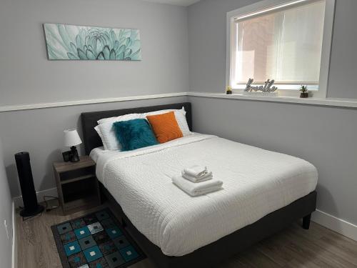 a bedroom with a bed and a window and a sink at Exquisite Cozy Suite/full amenities in Kensington in Saskatoon