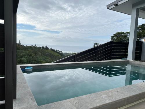 a swimming pool with a view of a mountain at Cozy hills studio in Faaa