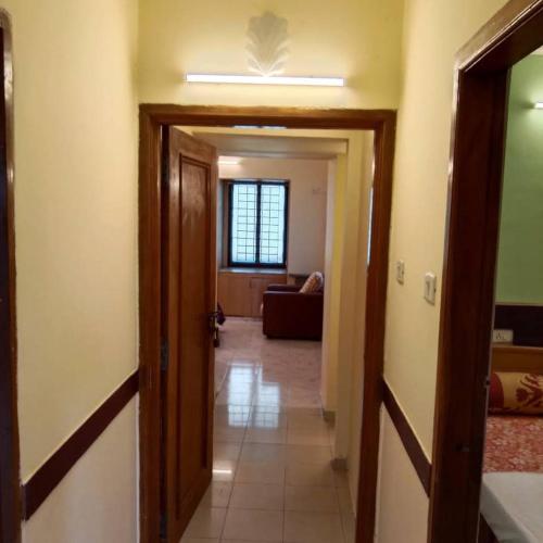 a hallway leading to a room with a living room at WISHTREE CORPORATE MENS DORMITORY FOR TECHIES AND Trainees in Chennai