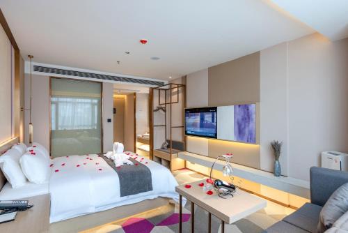 Habitación de hotel con cama y TV en Lavande Hotel Chaoshan International Airport, en Chaozhou