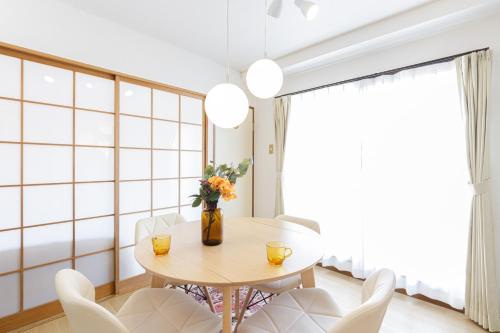 a dining room with a table and chairs at The Dove House Quiet Apartment near Haneda Airport in Tokyo
