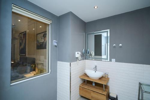 a bathroom with a white sink and a mirror at Zimmer Boutique Hotel in Baku