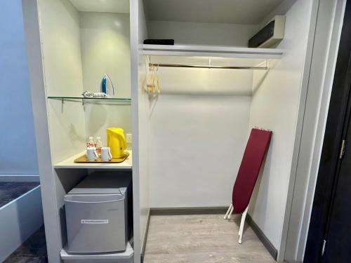 a closet with a desk and a chair in a room at Permai Hotel Kuala Terengganu in Kuala Terengganu