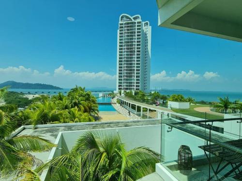 a view of the ocean from the balcony of a building at Southbay Seaview Condo A11 #Queensbay #SPICE in Bayan Lepas