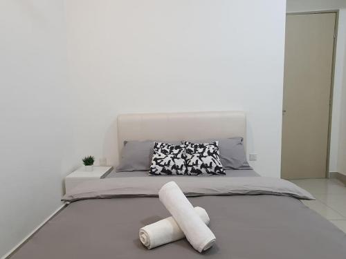 a white bedroom with a bed with two white towels at Southbay Seaview Condo A11 #Queensbay #SPICE in Bayan Lepas