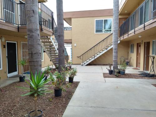 a walkway in front of a building with palm trees at Charming 1Bedroom Vacation Condo in Oceanside