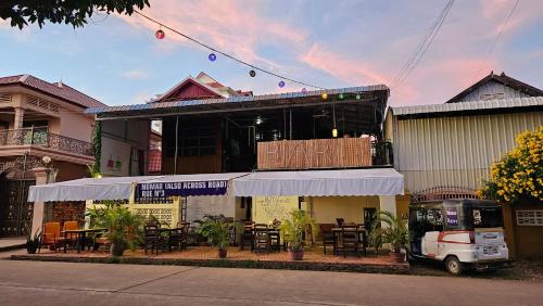 a restaurant with tables and chairs in front of a building at Nomad Guesthouse in Kratie