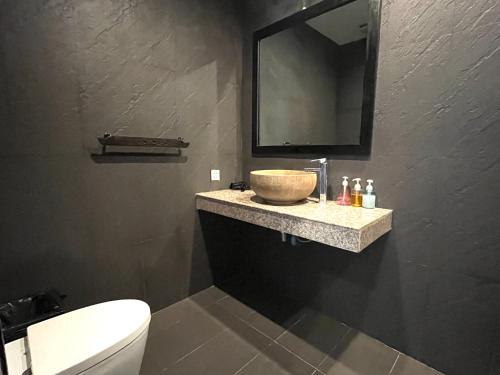 a bathroom with a sink and a mirror at Prana Hotel in Siem Reap
