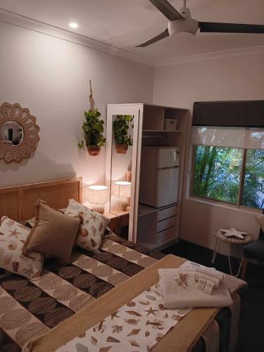 a bedroom with a large bed and a window at Ningaloo Lodge Exmouth in Exmouth