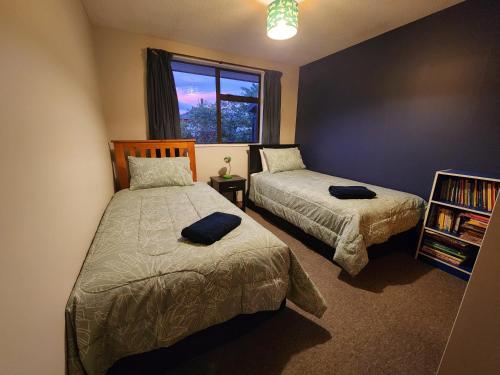 a bedroom with two beds and a window at Rockhampton in Kurow