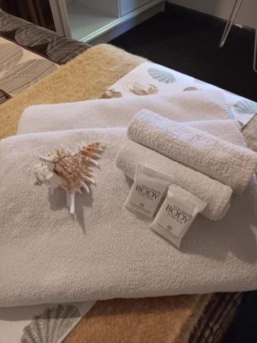a pile of towels sitting on top of a bed at Ningaloo Lodge Exmouth in Exmouth