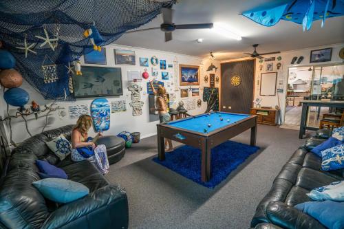 a living room with a pool table in it at Ningaloo Lodge Exmouth in Exmouth