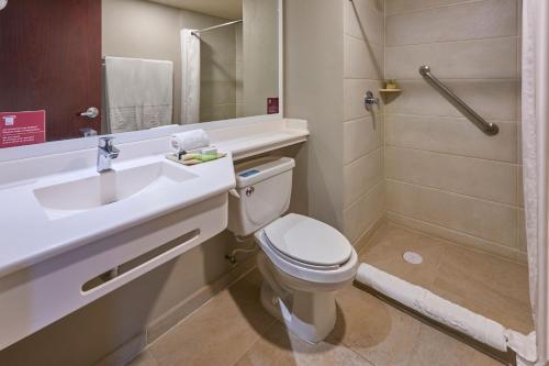 a bathroom with a toilet and a sink and a shower at City Express Suites by Marriott Tijuana Rio in Tijuana