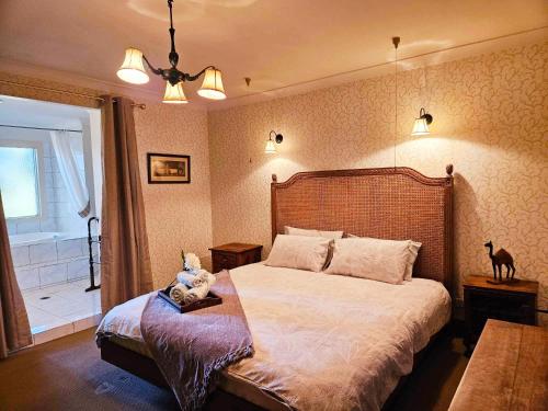 a bedroom with a bed and a window with a cat on it at The Gamekeepers Spa Cottage in Tamborine Mountain in Mount Tamborine